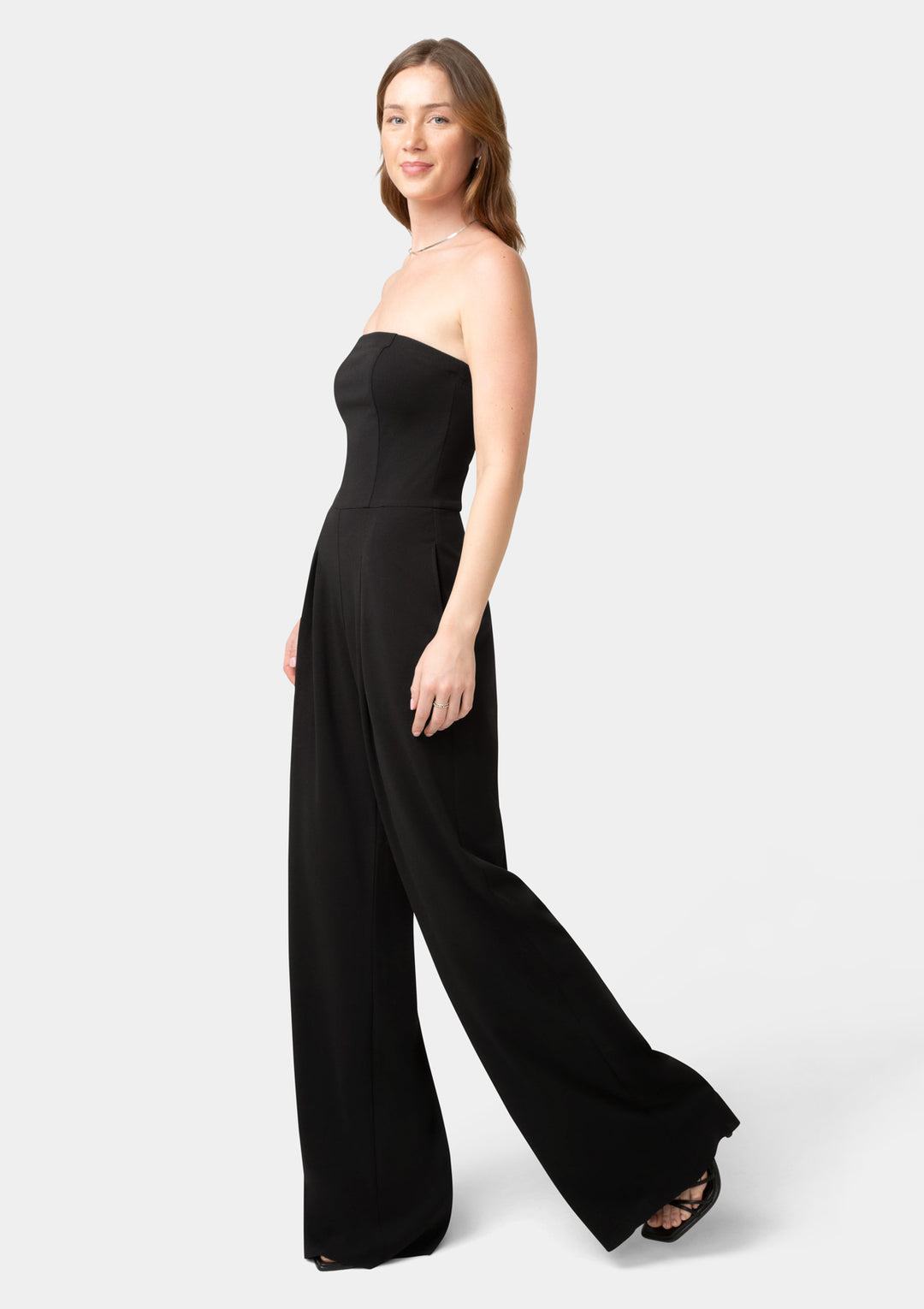 Woman wearing a black strapless jumpsuit