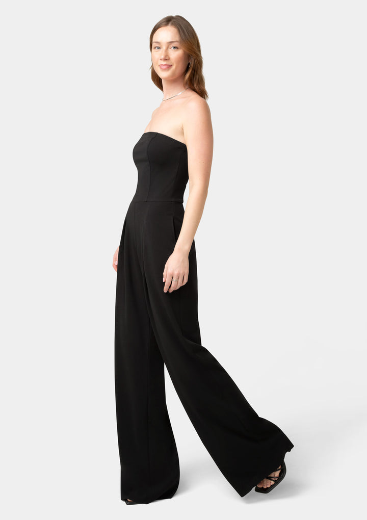 Woman wearing a black strapless jumpsuit