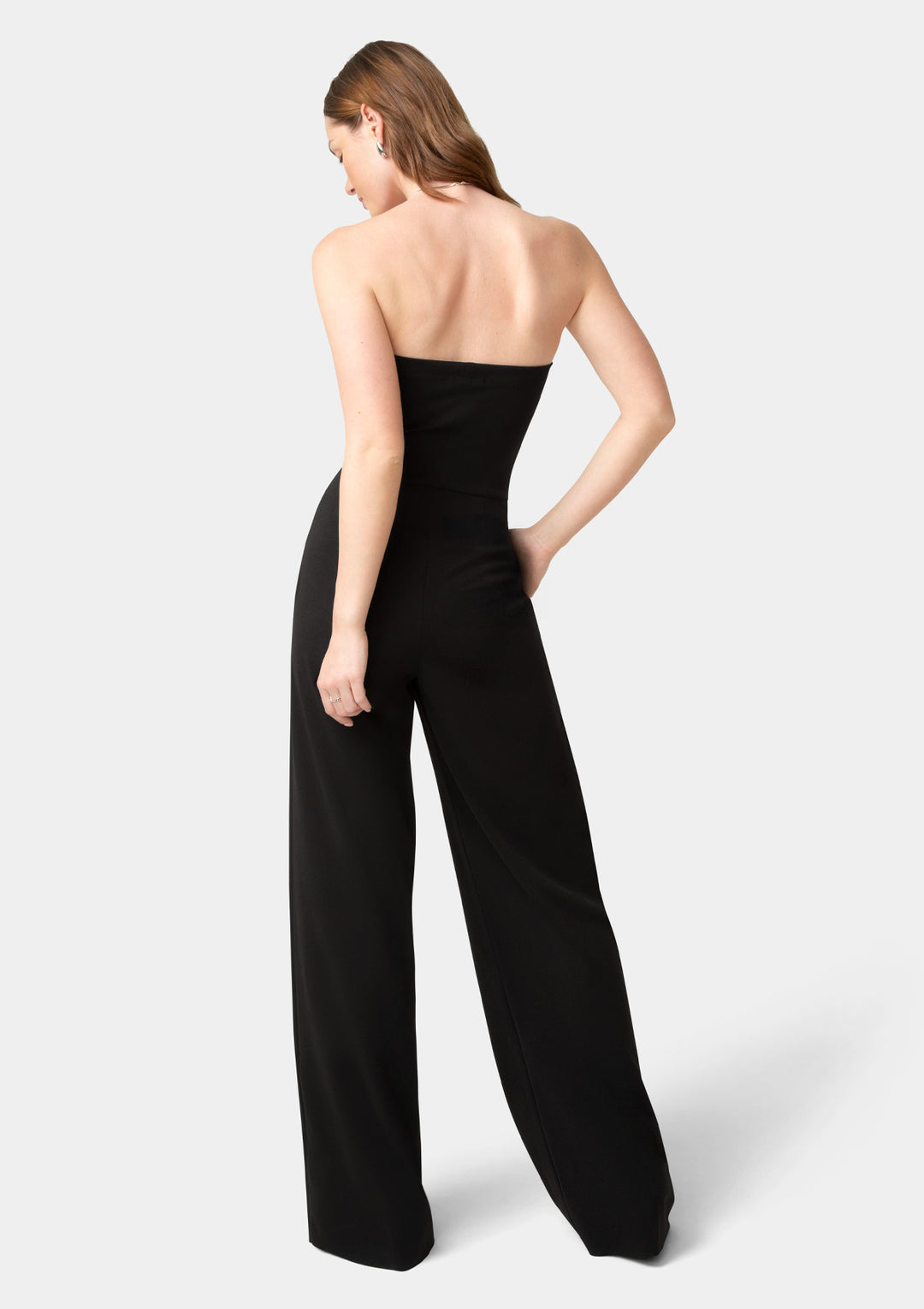 Woman wearing a black strapless jumpsuit