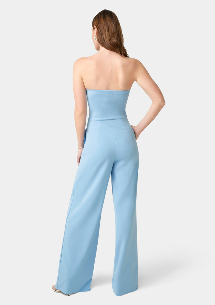 Woman wearing a light blue strapless jumpsuit