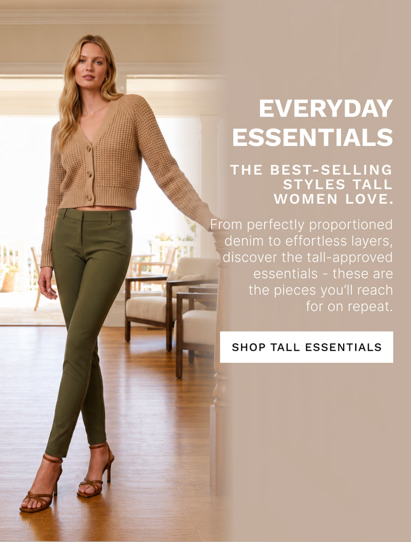 A woman stands in a bright indoor room wearing a beige ribbed cardigan and olive green slim-fit pants, with promotional text on the right reading 'EVERYDAY ESSENTIALS' and 'SHOP TALL ESSENTIALS.' Because a person and real interior environment are visible, this is Lifestyle rather than Product/Packaging.